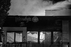 A burning Wendy’s in so-called “Atlanta”, lit on fire in retaliation for the murder of Rayshard Brooks by the police in the summer of 2020. The windows are broken. On the furthest left is a tag that says “RIP Rayshard”. On the building’s center is a tag that says “F12” which means fuck the police. If this Wendy’s was still up today, then its operation would had inherently lead to the murder of numerous disabled people via COVID spread.